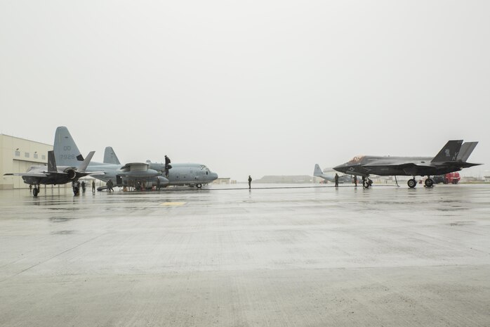 Two U.S. Marine Corps F-35B Lightning II aircraft with Marine Fighter Attack Squadron (VMFA) 121 refuel using a KC-130J Hercules with Marine Aerial Refueler Transport Squadron (VMGR) 152 during aviation delivered ground refueling training at Marine Corps Air Station Iwakuni, Japan, April 11, 2017. The ADGR marked the first evolution of this form of refueling for VMFA-121’s F-35B Lightning II aircraft, and it increases the squadron’s ability to refuel by C-130 aircraft in austere locations when other resources may not be available.  (U.S. Marine Corps photo by Lance Cpl. Joseph Abrego)
