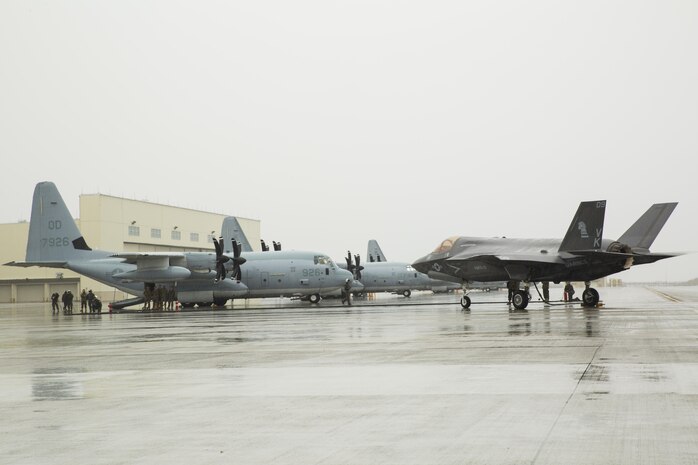 A U.S. Marine Corps F-35B Lightning II aircraft with Marine Fighter Attack Squadron (VMFA) 121 refuels using a KC-130J Hercules with Marine Aerial Refueler Transport Squadron (VMGR) 152 during aviation delivered ground refueling training at Marine Corps Air Station Iwakuni, Japan, April 11, 2017. The ADGR marked the first evolution of this form of refueling for VMFA-121’s F-35B Lightning II aircraft, and it increases the squadron’s ability to refuel by C-130 aircraft in austere locations when other resources may not be available.  (U.S. Marine Corps photo by Lance Cpl. Joseph Abrego)