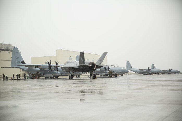 A U.S. Marine Corps F-35B Lightning II aircraft with Marine Fighter Attack Squadron (VMFA) 121 refuels using a KC-130J Hercules with Marine Aerial Refueler Transport Squadron (VMGR) 152 during aviation delivered ground refueling training at Marine Corps Air Station Iwakuni, Japan, April 11, 2017. The ADGR marked the first evolution of this form of refueling for VMFA-121’s F-35B Lightning II aircraft, and it increases the squadron’s ability to refuel by C-130 aircraft in austere locations when other resources may not be available.  (U.S. Marine Corps photo by Lance Cpl. Joseph Abrego)