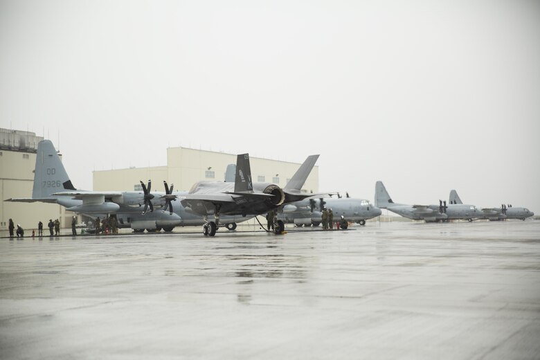 A U.S. Marine Corps F-35B Lightning II aircraft with Marine Fighter Attack Squadron (VMFA) 121 refuels using a KC-130J Hercules with Marine Aerial Refueler Transport Squadron (VMGR) 152 during aviation delivered ground refueling training at Marine Corps Air Station Iwakuni, Japan, April 11, 2017. The ADGR marked the first evolution of this form of refueling for VMFA-121’s F-35B Lightning II aircraft, and it increases the squadron’s ability to refuel by C-130 aircraft in austere locations when other resources may not be available.  (U.S. Marine Corps photo by Lance Cpl. Joseph Abrego)