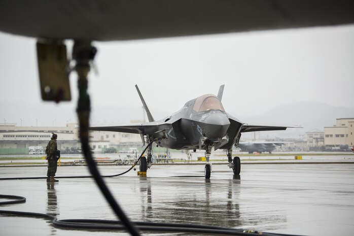 A U.S. Marine Corps F-35B Lightning II aircraft with Marine Fighter Attack Squadron (VMFA) 121 refuels using a KC-130J Hercules with Marine Aerial Refueler Transport Squadron (VMGR) 152 during aviation delivered ground refueling training at Marine Corps Air Station Iwakuni, Japan, April 11, 2017. The ADGR marked the first evolution of this form of refueling for VMFA-121’s F-35B Lightning II aircraft, and it increases the squadron’s ability to refuel by C-130 aircraft in austere locations when other resources may not be available.  (U.S. Marine Corps photo by Lance Cpl. Joseph Abrego)