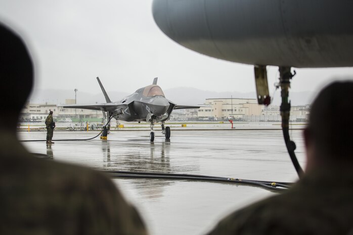 A U.S. Marine Corps F-35B Lightning II aircraft with Marine Fighter Attack Squadron (VMFA) 121 refuels using a KC-130J Hercules with Marine Aerial Refueler Transport Squadron (VMGR) 152 during aviation delivered ground refueling training at Marine Corps Air Station Iwakuni, Japan, April 11, 2017. The ADGR marked the first evolution of this form of refueling for VMFA-121’s F-35B Lightning II aircraft, and it increases the squadron’s ability to refuel by C-130 aircraft in austere locations when other resources may not be available.  (U.S. Marine Corps photo by Lance Cpl. Joseph Abrego)