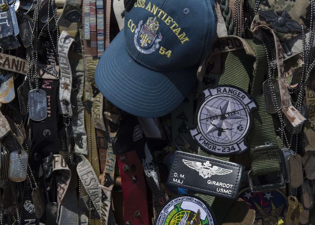 An assortment of military mementos decorate a memorial of the summit of Mt. Suribachi on March 30, 2017, at Iwo Jima, Japan. The mountain top is a site famous for the flag raising photo taken during the battle of Iwo Jima (U.S. Air Force photo by Airman 1st Class Juan Torres)