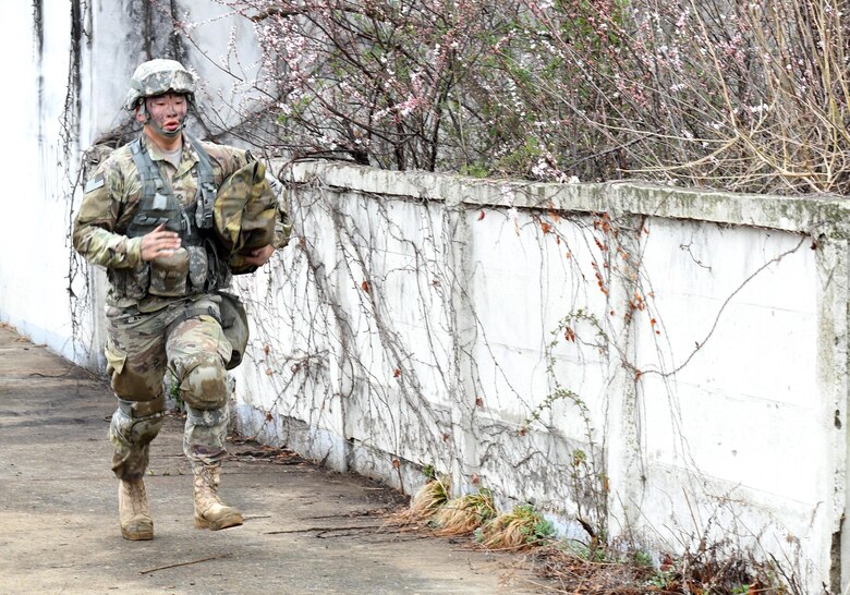 U.S. Army Pfc. Sung Hoon Lee, 2nd Battalion, 1st Air Defense Artillery medic, runs down one of two combat trauma lanes during the 35th Air Defense Artillery Brigade Expert Field Medical Badge preliminary competition at Osan Air Base, Republic of Korea, April 6, 2017. Within the lanes, participant’s skills, determination and strength were tested through scenarios such as medical management, care under fire, tactical movement, decontamination and litter movement. (U.S. Air Force photo by Staff Sgt. Alex Fox Echols III)