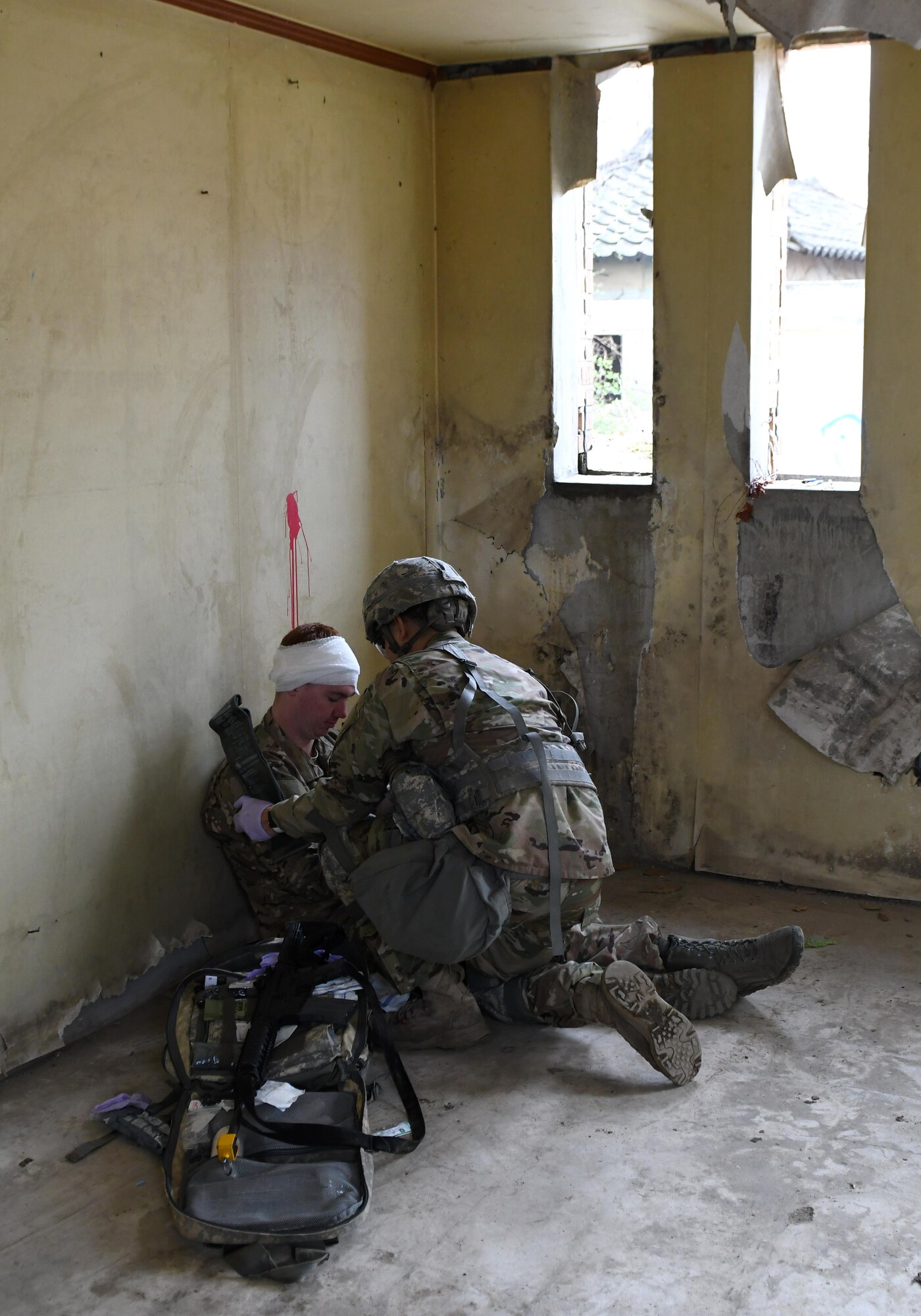 U.S. Army Staff Sgt. Santiago Sendejas, 6th Battalion, 52nd Air Defense Artillery medical NCO in charge, treats a simulated casualty during the 35th Air Defense Artillery Brigade Expert Field Medical Badge preliminary competition at Osan Air Base, Republic of Korea, April 6, 2017. The goal of the competition was to bring together medics for training and determine which have the ability and resolve to win at the 8th Army’s Expert Field Medical Badge Competition. (U.S. Air Force photo by Staff Sgt. Alex Fox Echols III)