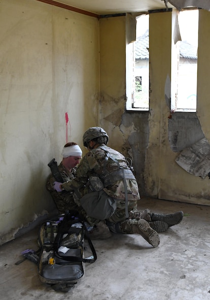 U.S. Army Staff Sgt. Santiago Sendejas, 6th Battalion, 52nd Air Defense Artillery medical NCO in charge, treats a simulated casualty during the 35th Air Defense Artillery Brigade Expert Field Medical Badge preliminary competition at Osan Air Base, Republic of Korea, April 6, 2017. The goal of the competition was to bring together medics for training and determine which have the ability and resolve to win at the 8th Army’s Expert Field Medical Badge Competition. (U.S. Air Force photo by Staff Sgt. Alex Fox Echols III)