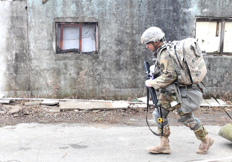 U.S. Army Staff Sgt. Santiago Sendejas, 6th Battalion, 52nd Air Defense Artillery medical NCO in charge, transports a simulated casualty down a combat trauma lane during the 35th Air Defense Artillery Brigade Expert Field Medical Badge preliminary competition at Osan Air Base, Republic of Korea, April 6, 2017. Within the two combat trauma lanes, participant’s skills, determination and strength were tested through scenarios such as medical management, care under fire, tactical movement, decontamination and litter movement. (U.S. Air Force photo by Staff Sgt. Alex Fox Echols III)