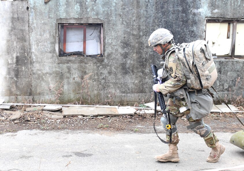 U.S. Army Staff Sgt. Santiago Sendejas, 6th Battalion, 52nd Air Defense Artillery medical NCO in charge, transports a simulated casualty down a combat trauma lane during the 35th Air Defense Artillery Brigade Expert Field Medical Badge preliminary competition at Osan Air Base, Republic of Korea, April 6, 2017. Within the two combat trauma lanes, participant’s skills, determination and strength were tested through scenarios such as medical management, care under fire, tactical movement, decontamination and litter movement. (U.S. Air Force photo by Staff Sgt. Alex Fox Echols III)