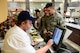 Airmen pay for their first lunch at the updated Dining Facility at Spangdahlem Air Base after several months of renovations that made meal service unavailable to the Saber community, April 10, 2017. Upgrades to the DFAC include new kitchen equipment like ovens and a walk in fridge, air conditioning installed in the kitchen, a new service line, repainting the walls and adding murals in the dining rooms to reflect the base's connection to the local community. (U.S. Air Force photo by Senior Airman Joshua R. M. Dewberry)