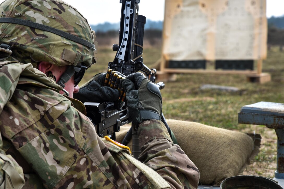 A soldier loads ammunition into his machine gun before participating in a zeroing range in Orzysz, Poland, April 3, 2017. Army photo by Spc. Nathanael Mercado