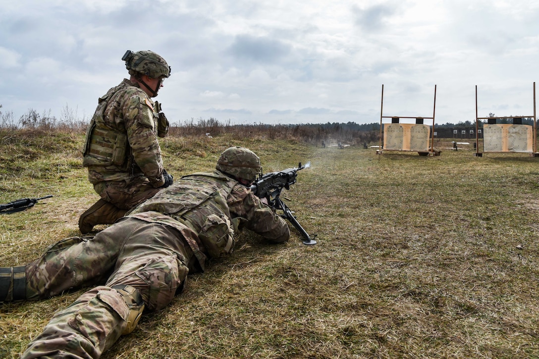 A range safety officer observes a soldier firing a machine gun at targets during a zeroing range in Orzysz, Poland, April 3, 2017. Army photo by Spc. Nathanael Mercado