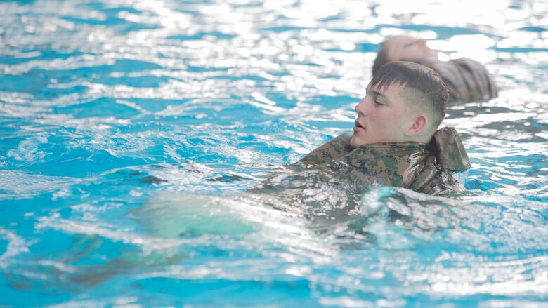 A Marine creates a floatation device using utility trousers during Water Survival-Advanced training at Marine Corps Base Camp Lejeune, N.C., April 4, 2017. WSA provides Marines the opportunity to become qualified rescue swimmers. The Marine is a student in the course, which is run by 2nd Law Enforcement Battalion.  