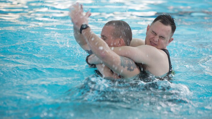 Marine Corps Instructors of Water Survival demonstrate rescue scenarios during Water Survival-Advanced training at Marine Corps Base Camp Lejeune, N.C., April 4, 2017. WSA is a week-long course that tests Marines on rescues, strokes and distance swimming. The Marines are WSA instructors from 2nd Law Enforcement Battalion. 