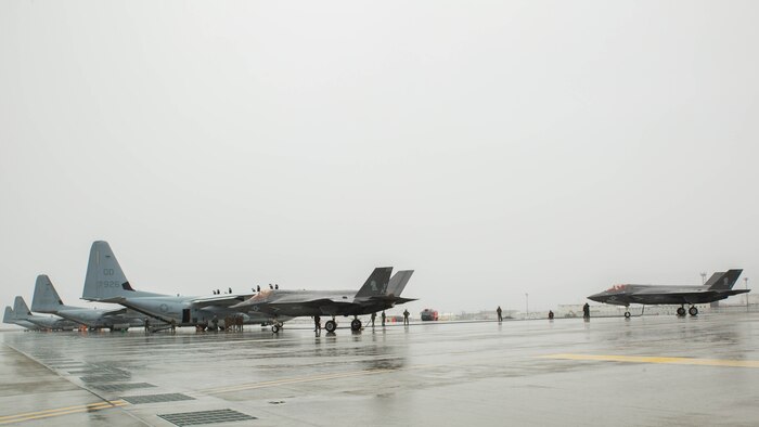 Two U.S. Marine Corps F-35B Lightning II aircraft with Marine Fighter Attack Squadron 121 refuel using a KC-130J Hercules with Marine Aerial Refueler Transport Squadron 152 during aviation delivered ground refueling training at Marine Corps Air Station Iwakuni, Japan, April 11, 2017. The ADGR marked the first evolution of this form of refueling for VMFA-121’s F-35B Lightning II aircraft, and it increases the squadron’s ability to refuel by C-130 aircraft in austere locations when other resources may not be available. 