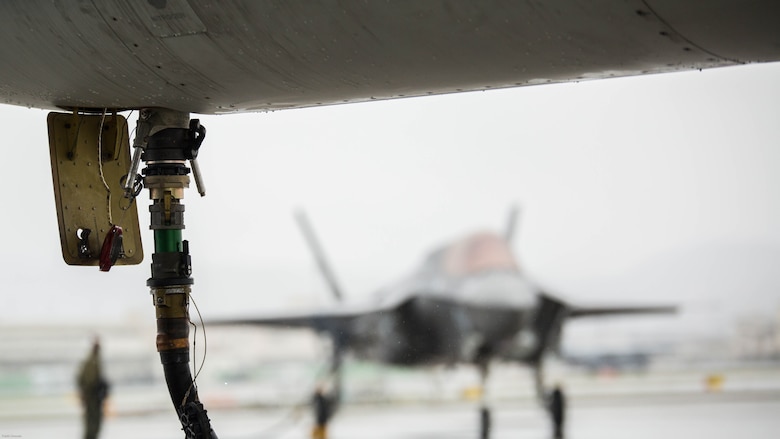 A hose attached to a KC-130J Hercules with Marine Aerial Refueler Transport Squadron 152 pumps fuel into an F-35B Lightning II aircraft with Marine Fighter Attack Squadron 121 during aviation delivered ground refueling training at Marine Corps Air Station Iwakuni, Japan, April 11, 2017. The ADGR marked the first evolution of this form of refueling for VMFA-121’s F-35B Lightning II aircraft, and it increases the squadron’s ability to refuel by C-130 aircraft in austere locations when other resources may not be available.  