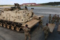 Soldiers of 2nd Battalion, 7th Infantry Regiment, 1st Armored Brigade Combat Team, 3rd Infantry Division, unload plywood to lay down for air load training March 28, 2017 at Hunter Army Airfield, Ga. The plywood was a barrier between the C5 "Super Galaxy" aircraft and the unit’s Abrams tanks and Bradley fighting vehicles. Soldiers of 2-7th Inf. make up the Immediate Ready Company, which maintains readiness to support the Global Response Force within 18 hours of notification. (U.S. Army photo by Staff Sgt. Candace Mundt/Released)
