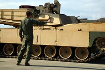 An airman with 9th Airlift Squadron, 436th Airlift Wing out of Dover Air Force Base, Del. directs an M1A1 Abrams tank off a C5 "Super Galaxy" aircraft during air load training March 28, 2017 at Hunter Army Airfield, Ga. Airman supported the Immediate Ready Company, comprised of Soldiers from 2nd Battalion, 7th Infantry Regiment, 1st Armored Brigade Combat Team, 3rd Infantry Division. The IRC maintains readiness to support the Global Response Force within 18 hours of notification. (U.S. Army photo by Staff Sgt. Candace Mundt/Released)