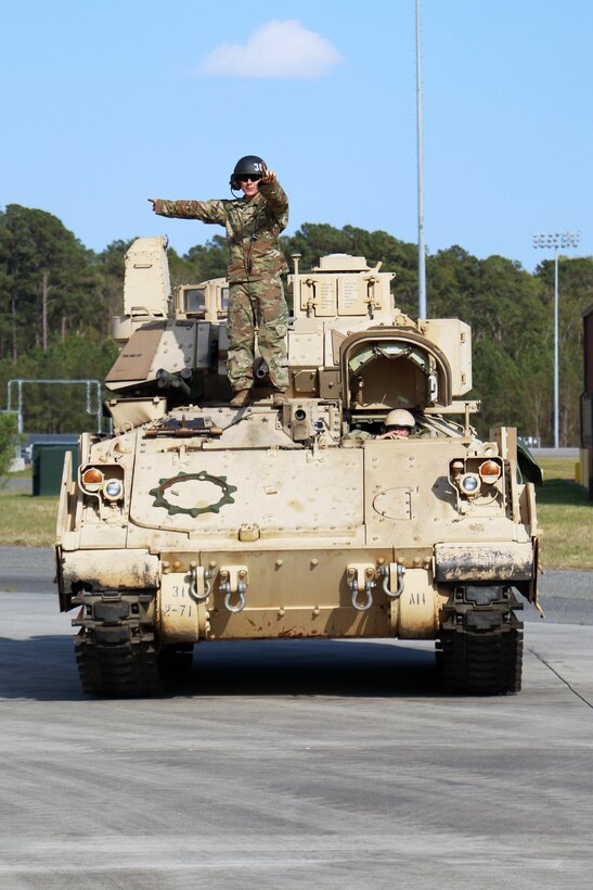 A Soldier with 2nd Battalion, 7th Infantry Regiment, 1st Armored Brigade Combat Team, 3rd Infantry Division gives directions to an air crewman before loading an M2A3 Bradley fighting vehicle onto a C5 "Super Galaxy" aircraft during air load training March 28, 2017 at Hunter Army Airfield, Ga. Soldiers of 2-7th Inf. make up the Immediate Ready Company, which maintains readiness to support the Global Response Force within 18 hours of notification. (U.S. Army photo by Staff Sgt. Candace Mundt/Released)