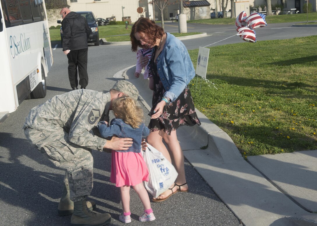 Master Sgt. Luke Young, air transportation craftsman, 46th Aerial Port Squadron, meets his wife, Rachel, and two daughters, Melody and Emory, after returning from a 6-month deployment, April 11, 2017, Dover Air Force Base. Young deployed for 6-months to Al Udeid Air Base, Qatar. (U.S. Air Force Photo/Tech. Sgt. Nathan Rivard)