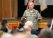 Col. Roman L. Hund, 66th Air Base Group commander, speaks to military and civilian personnel at an ABG commander’s call at the base theater April 11. During the call, personnel received updates on the Unit Effectiveness Inspection scheduled in July, learned the Air Force Assistance Fund campaign has been extended to April 28 and was told the base would have a cleanup day May 12. (U.S. Air Force photo by Linda LaBonte Britt)