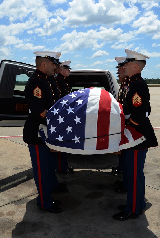 Marines attached to Marine Corps Logistics Base Albany funeral detail carry a casket with the remains of Marine Pfc. James O. Whitehurst to a hearse at the Tallahassee International Airport in Tallahassee, Fla., April 11. Whitehurst was killed in action at the battle of Tarawa during World War II, Nov. 20, 1943.