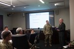 DLA Distribution commander Army Brig. Gen. John Laskodi presents DLA Land and Maritime deputy commander Jim McClaugherty, Senior Executive Service, with a token of appreciation in honor of his upcoming retirement.  