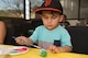 Adiel Figueroa paints a wooden egg during an event at the Information Learning Center April 11. The “Egg-cellent Decorating“ event had children painting wooden eggs as well as other arts and crafts to welcome in spring. (U.S. Air Force photo by Jerry Saslav)