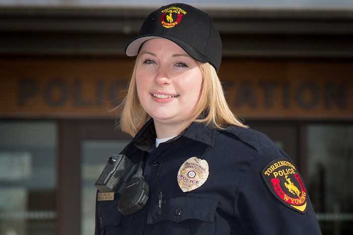 Air Force Staff Sgt. Rebekah Miller stands in uniform in front of the Torrington police department.