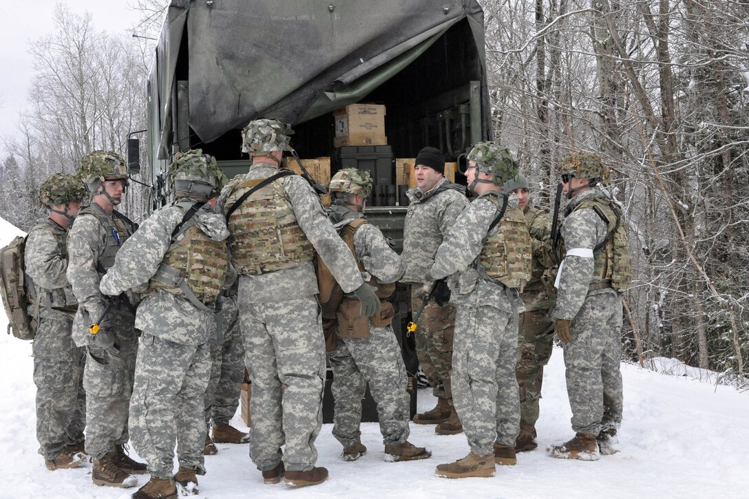 Soldiers gather blank rounds before conducting squad-level training at Camp Ethan Allen Training Site in Jericho, Vt., April 8, 2017. The soldiers practiced going through lanes multiple times to prepare for annual training later in the year. Army National Guard photo by Staff Sgt. Ashley Hayes