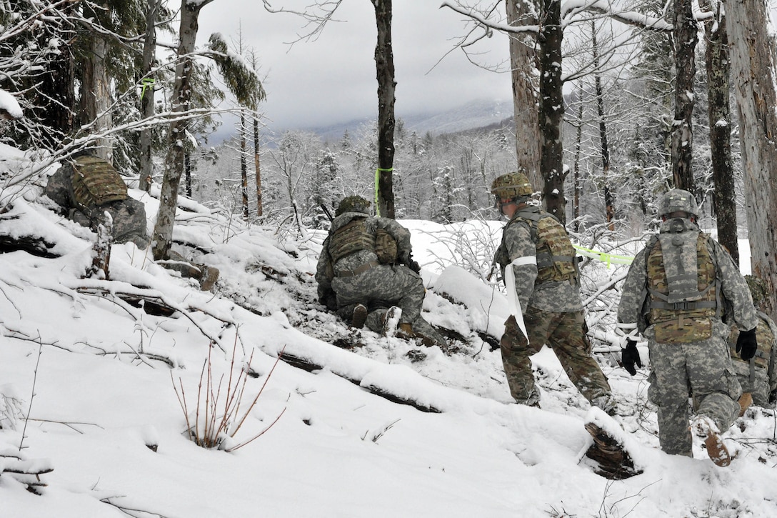 Soldiers take firing positions during squad-level training at Camp Ethan Allen Training Site in Jericho, Vt., April 8, 2017. The soldiers were training to provide support by fire to other squad members conducting assault team exercises downrange from their position. Army National Guard photo by Staff Sgt. Ashley Hayes