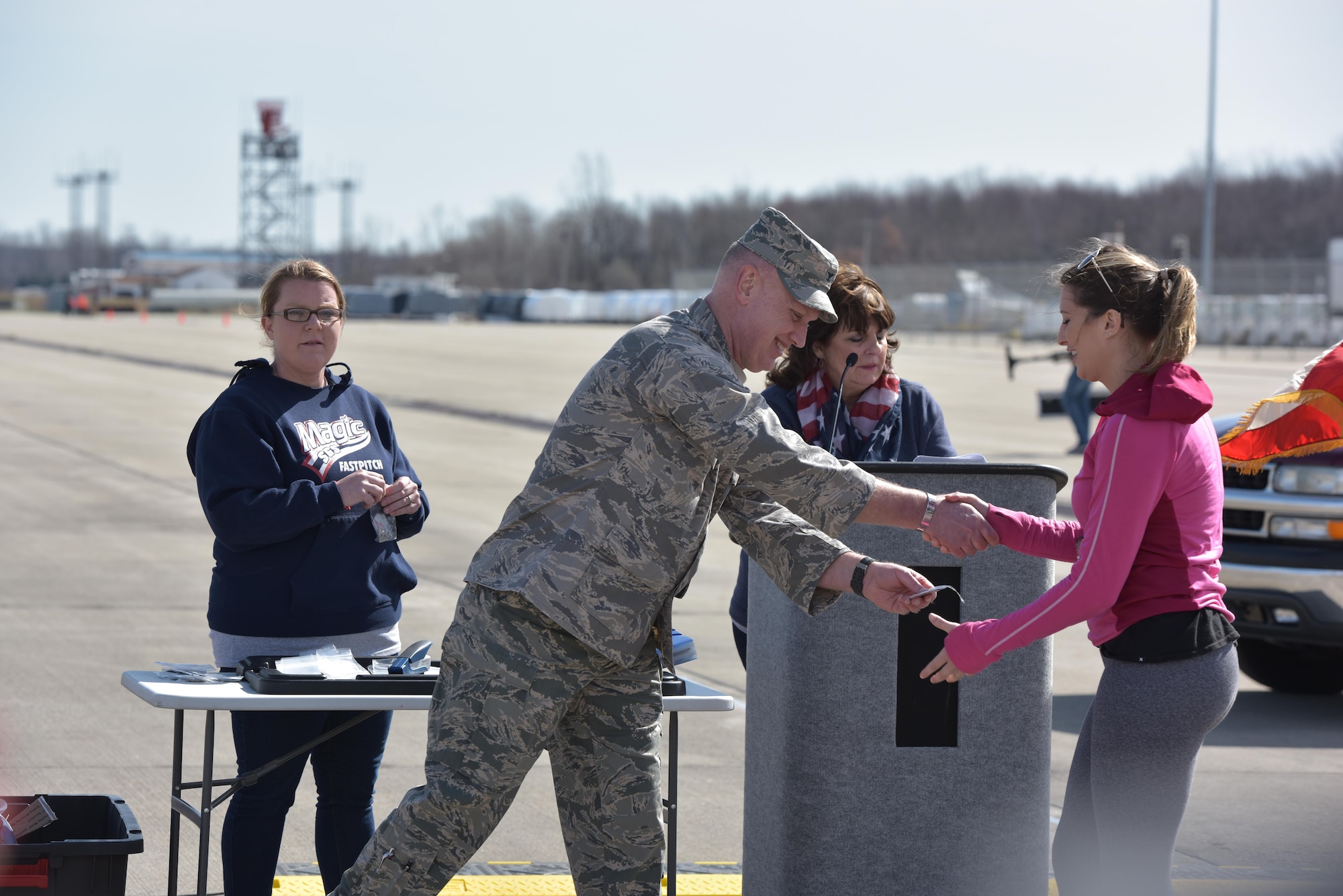 Col. Kevin Doyle, Commander of the Ohio Air National Guard’s 180th Fighter Wing, presents a runner with an award for winning her age group in the I Believe I Can Fly 5K at the Toledo Express Airport April 9, 2017 in Swanton, Ohio. The 180FW participates in community events to give back and maintain a strong relationship with the Ohio community. The race, now in its third year, provides runners of all ages, the rare opportunity to run a unique course, down the taxiways used by Northwest Ohio’s very own 180FW, while also promoting awareness and raising funds to benefit our veterans who have given so much to our great nation. (U.S. Air National Guard photo by Tech. Sgt. Nic Kuetemeyer)