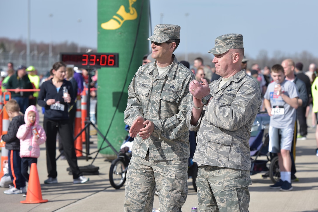 U.S. Air Force Col. Kevin Doyle, commander of the 180th Fighter Wing, Ohio Air National Guard and Chief Master Sgt. John Deraedt, command chief master sergeant assigned to the wing, cheer on runners as they finish the I Believe I Can Fly 5k race at the Toledo Express Airport in Swanton, Ohio on April 9, 2017. The wing’s Company Grade Officer Council partnered with the non-profit organization, The Arms Forces, as well as local law enforcement, fire departments and civilian volunteers to hold the third annual race which had approximately 270 participants, to raise awareness for military members with post-traumatic stress disorder and traumatic brain injury. The race, now in its third year, provides runners of all ages, the rare opportunity to run a unique course, down the taxiways used by Northwest Ohio’s very own 180FW, while also promoting awareness and raising funds to benefit our veterans who have given so much to our great nation. (U.S. Air National Guard photo by Tech. Sgt. Nic Kuetemeyer)