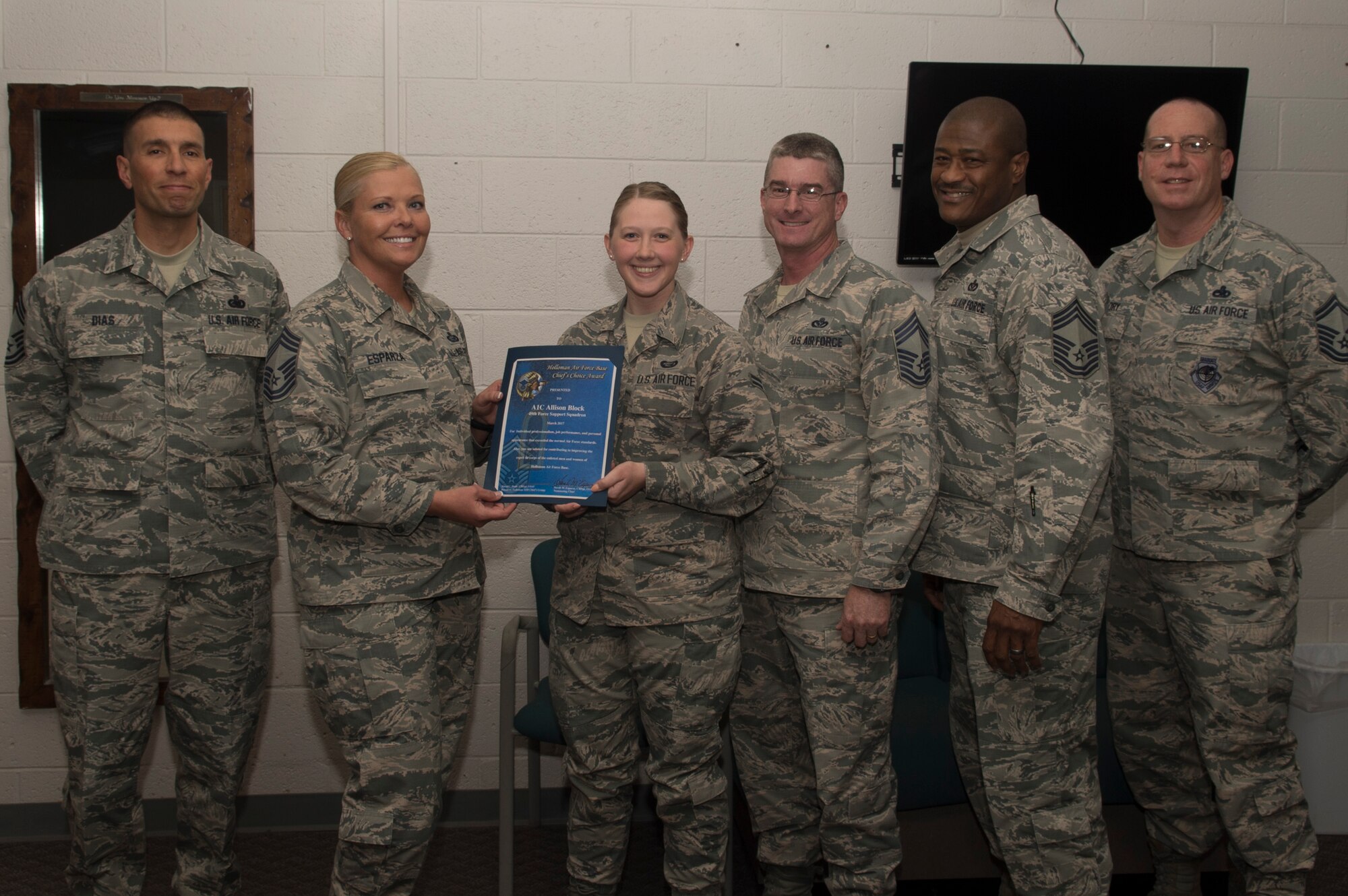 Airmen 1st Class Allison S. Block, a 49th Force Support Squadron career development apprentice, receives the March Chief’s Choice Award, from Chief Master Sergeant Sarah Esparza, the 49th FSS superintendent, April 10, 2017, at Holloman Air Force Base, N.M. (U.S. Air Force photo by Tech. Sgt. Amanda Junk)