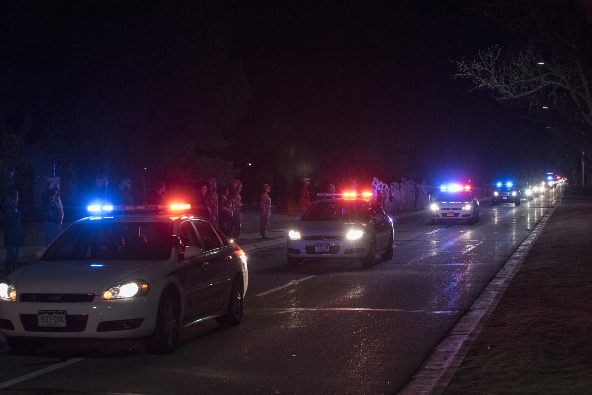 PETERSON AIR FORCE BASE, Colo. – Members of Team Pete pay their respects as members of the 21st Security Forces Squadron drive by during a dignified transfer for SSgt. Austin Bieren, a 21st Space Wing security forces Airman, at Peterson Air Force Base, Colo., April 7, 2017. Bieren died in a non-combat related incident while deployed in support of combat operations March 28, 2017. (U.S. Air Force photo by Senior Airman Rosemary Gudex)