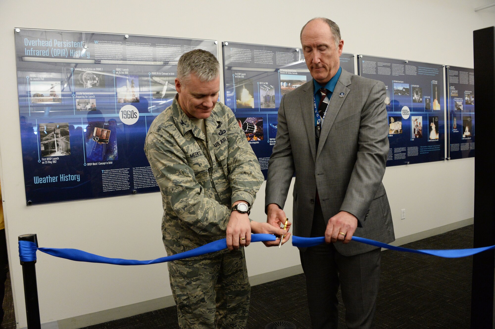 Col. Tony Meeks, deputy director of the Space and Missile Systems Center’s Remote Sensing Systems Directorate, and Dr. Steve Pluntze, RS Directorate executive director and civilian deputy director, cut a ceremonial ribbon to unveil the Remote Sensing Heritage Wall at Los Angeles Air Force Base in El Segundo, Calif., March 15, 2017. The ceremony commemorates an SMC mission that spans nearly six decades of providing global, persistent, infrared surveillance and environmental monitoring capabilities to our warfighters and the nation. (U.S. Air Force photo / Van De Ha)