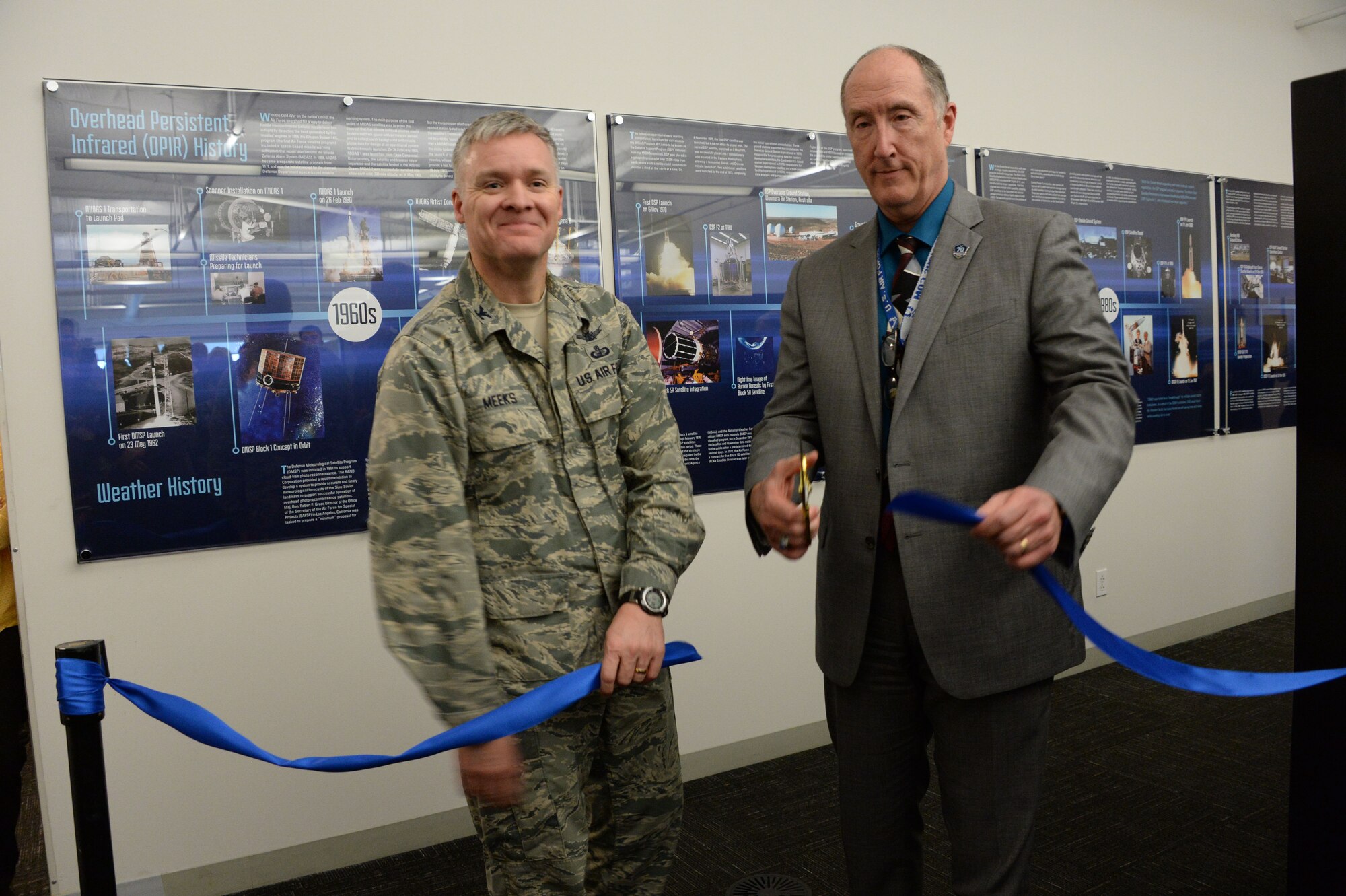 Col. Tony Meeks, deputy director of the Space and Missile Systems Center’s Remote Sensing Systems Directorate, and Dr. Steve Pluntze, RS Directorate executive director and civilian deputy director, cut a ceremonial ribbon to unveil the Remote Sensing Heritage Wall at Los Angeles Air Force Base in El Segundo, Calif., March 15, 2017. The ceremony commemorates an SMC mission that spans nearly six decades of providing global, persistent, infrared surveillance and environmental monitoring capabilities to our warfighters and the nation. (U.S. Air Force photo / Van De Ha)