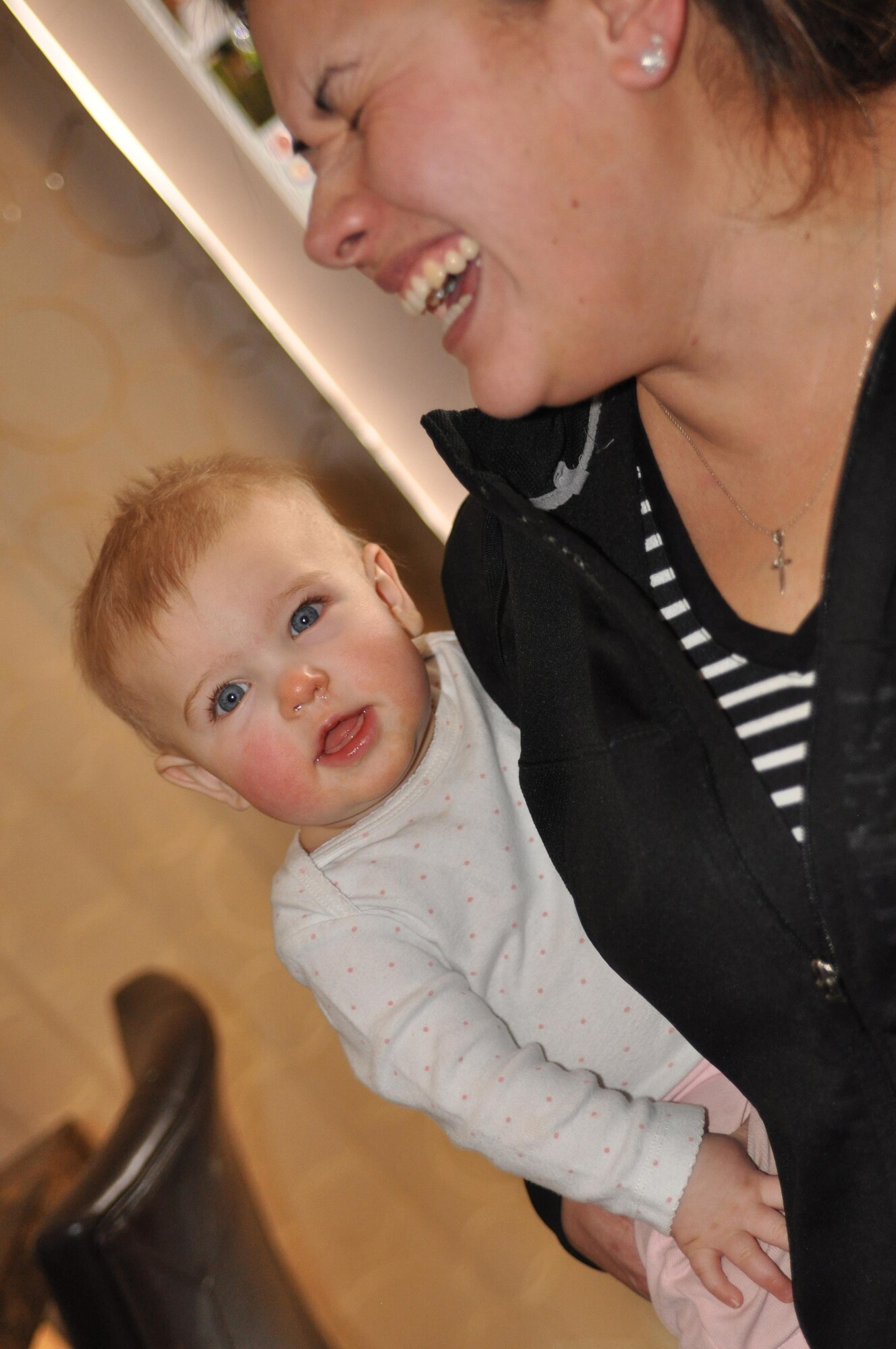 COLORADO SPRINGS, Colo.— Irene Penaflor, a Family Child Care provider, laughs while caring for nine month old Sydney at home in Colorado Springs, Colo., Feb. 7, 2017. Penaflor became an FCC provider 11 years ago when she chose to stay home with her own son who had health issues. (courtesy photo)