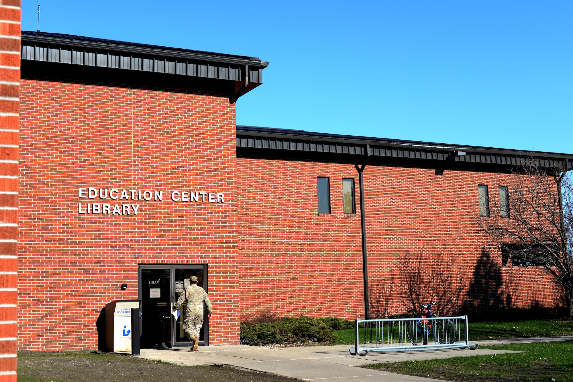 An Airman enters the Minot Air Force Base Library, April 9, 2017. The library offers books, DVDs, CDs, audiobooks, library orientations, computer study material and more. (U.S. Air Force photo/Airman 1st Class Austin M. Thomas)