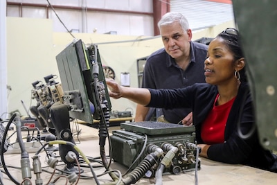 Honorable Steffanie Easter, the acting assistant secretary of the army for acquisition, logistics and technology for the Army, uses the Blue Force Tracker, a GPS-enabled system, during a capabilities visit with the ALT team at Camp Arifjan, Kuwait, April 11. Easter’s visit provided her the opportunity to see firsthand the capabilities of the troops within the area. (U.S. Army photo by Sgt. Bethany Huff, ARCENT Public Affairs)