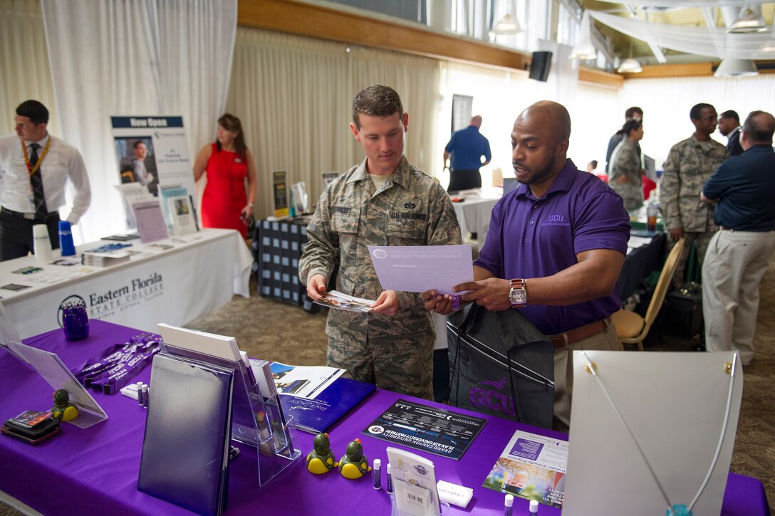 Staff Sgt. Garrett Brissey, 45th Civil Engineer Squadron structural journeyman, and a military admissions representative from Grand Canyon University, discuss options during an Education Fair at Patrick Air Force Base, Fla. April 4, 2017. During the event, Airmen meet face-to-face with school representatives and got their questions answered by more than 40 colleges and universities in attendance. (U.S. Air Force photo by Derwin Oviedo) 
