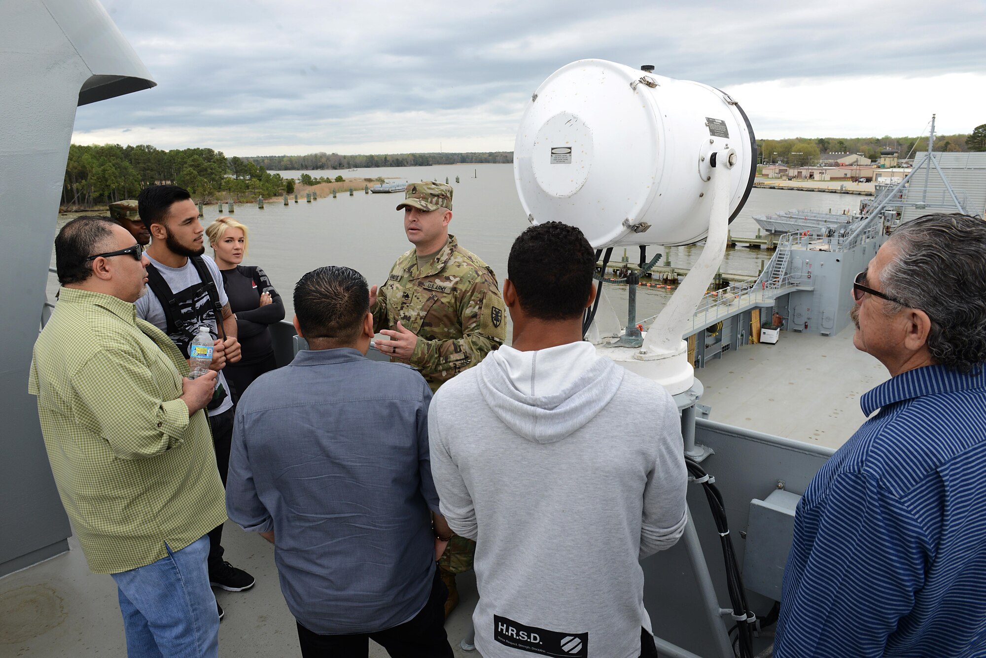 U.S. Army Staff Sgt. Ralph Genovese, 335th Transportation Detachment training NCO, guides UFC Fighters and guests on a tour of the Logistic Support Vessel Gen. Frank S. Besson Jr. at Joint Base Langley-Eustis, Va., April 6, 2017. The fighters interacted with community members during meet-and-greet events at the Fort Eustis Exchange, bowling alley and Anderson Field House. (U.S. Air Force photo/Staff Sgt. Teresa J. Cleveland)