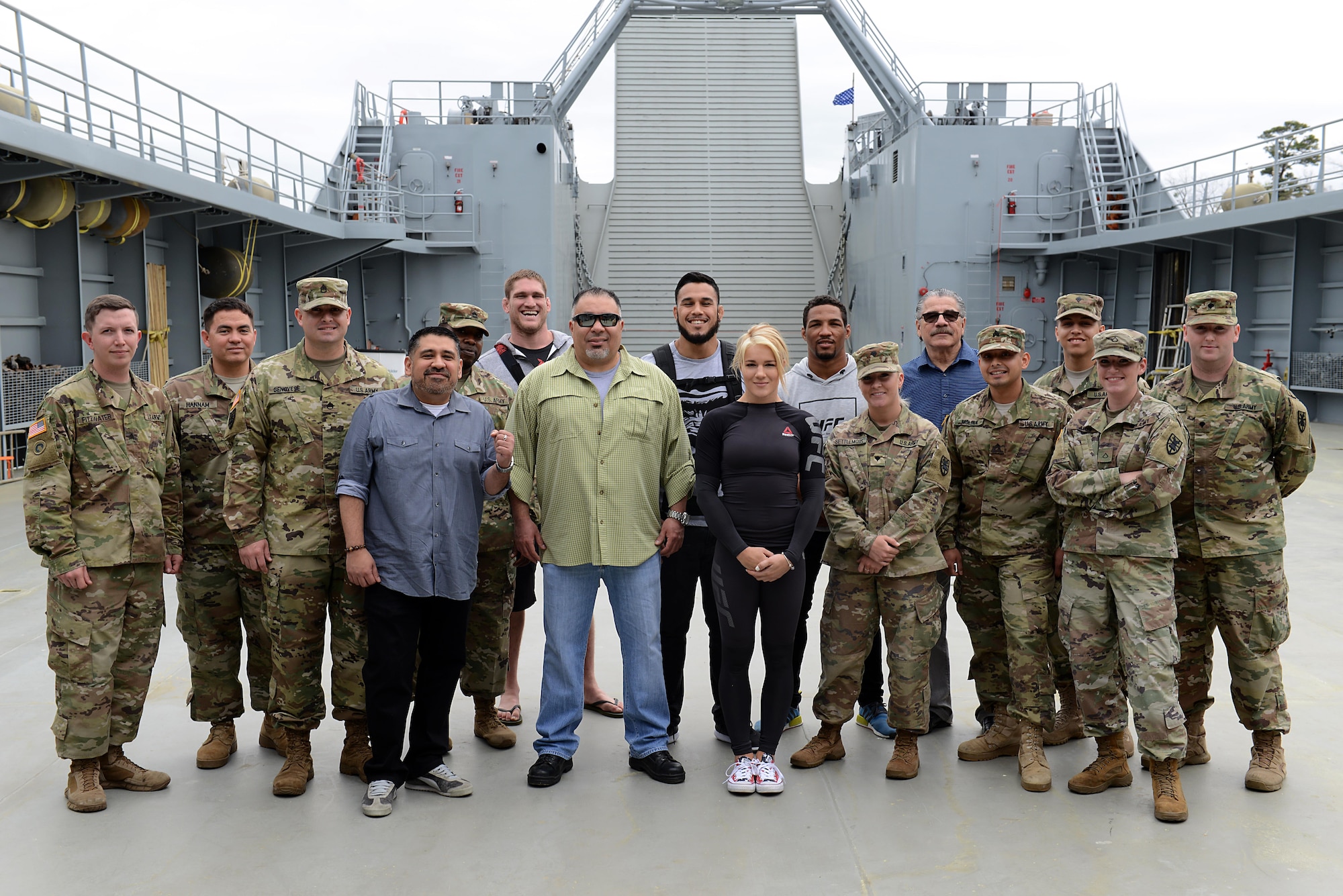 UFC Fighters and guests pose for a group photo with U.S. Army Soldiers assigned to the 335th Transportation Detachment at Joint Base Langley-Eustis, Va., April 6, 2017. During the visit, Soldiers explained the unique capabilities of Army watercraft and other deployable assets.  (U.S. Air Force photo/Staff Sgt. Teresa J. Cleveland)