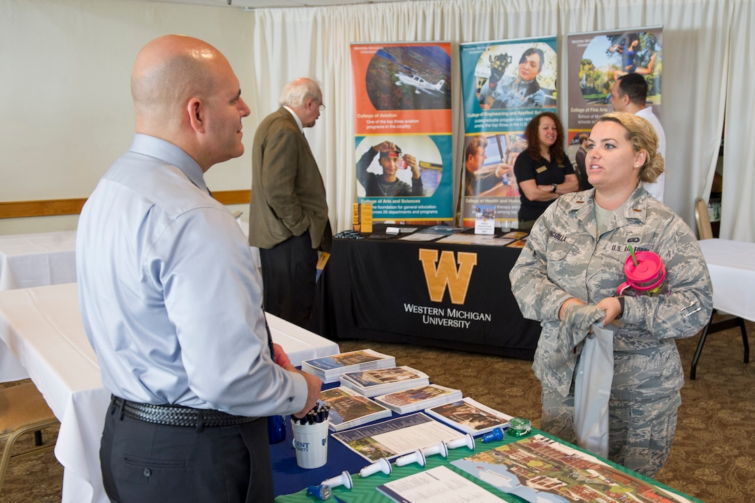 Second Lt. Leah Vincuilla, 45th Force Support Squadron sustainment services deputy flight commander, engages in conversation with a representative from Regent University, during an Education Fair at Patrick Air Force Base, Fla. April 4, 2017. The event was designed to open doors for military, civilians, and family members to explore educational and certification programs available to them from participating schools and vendors. (U.S. Air Force photo by Derwin Oviedo) 