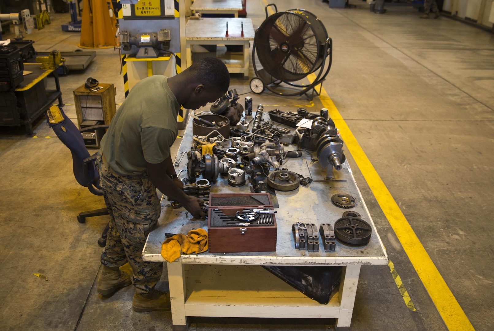 Marine Corps Cpl. Marcus Hardimon cleans a gasket on a valve cover, Nov. 8, 2016, at Camp Kinser, Okinawa, Japan. Marines took apart, cleaned, and assembled an engine of a High Mobility Multipurpose Wheeled Vehicle. Hardimon is an automotive maintenance technician with 3rd Marine Logistics Group, III Marine Expeditionary Force.