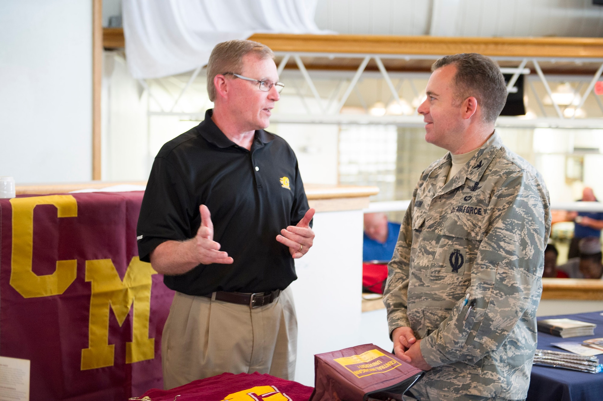 Col. Walt Jackim, 45th Space Wing vice commander, engages in conversation with an educational representative from Central Michigan University during an Education Fair at Patrick Air Force Base, Fla. April 4, 2017. Whether Airmen are at the beginning of their journey or planning to continue on, the event was a step in the right direction for those seeking higher education. (U.S. Air Force photo by Derwin Oviedo) 