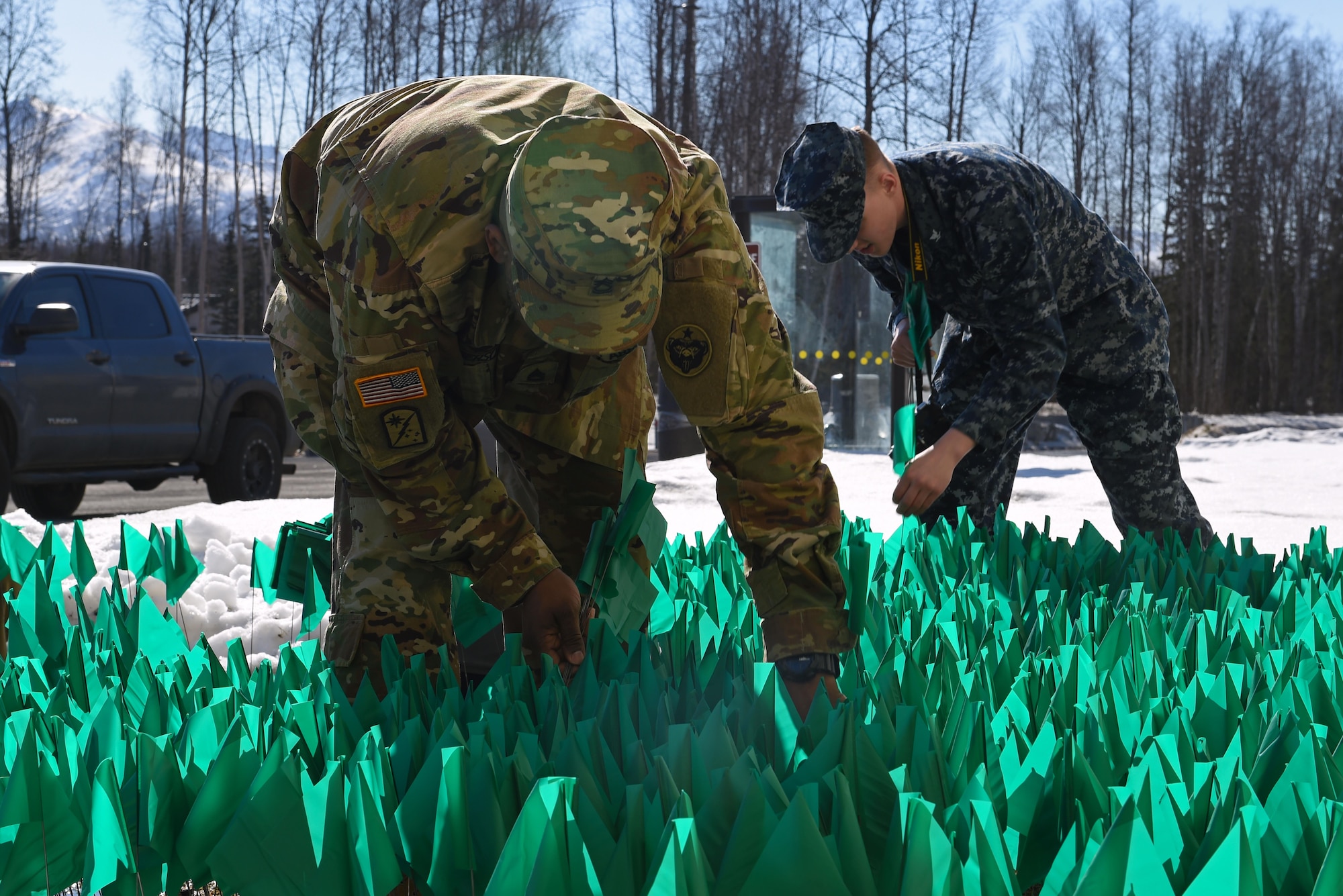 Joint Base Elmendorf-Richardson service members and personnel participate in the Teal Flag Project at the JBER Commissary, Alaska, April 11, 2017. The Teal Flag Project is a silent exhibit illustrating the number of sexual assaults in a given fiscal year. Each of the 3,828 flags planted represent a survivor who reported a sexual assault through the Sexual Assault Prevention and Response Office and the Sexual Harassment and Assault Response Prevention programs across the Air Force and Army departments during fiscal year 2015. 
