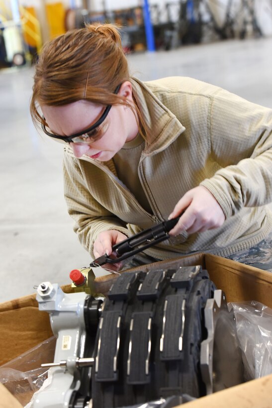 Pennsylvania Air National Guard Airman 1st Class Reanna Keener moves a shuttle valve to the correct side of an aircraft brake assembly in Middletown, Pa., April 5, 2017. Air National Guard photo by Master Sgt. Culeen Shaffer