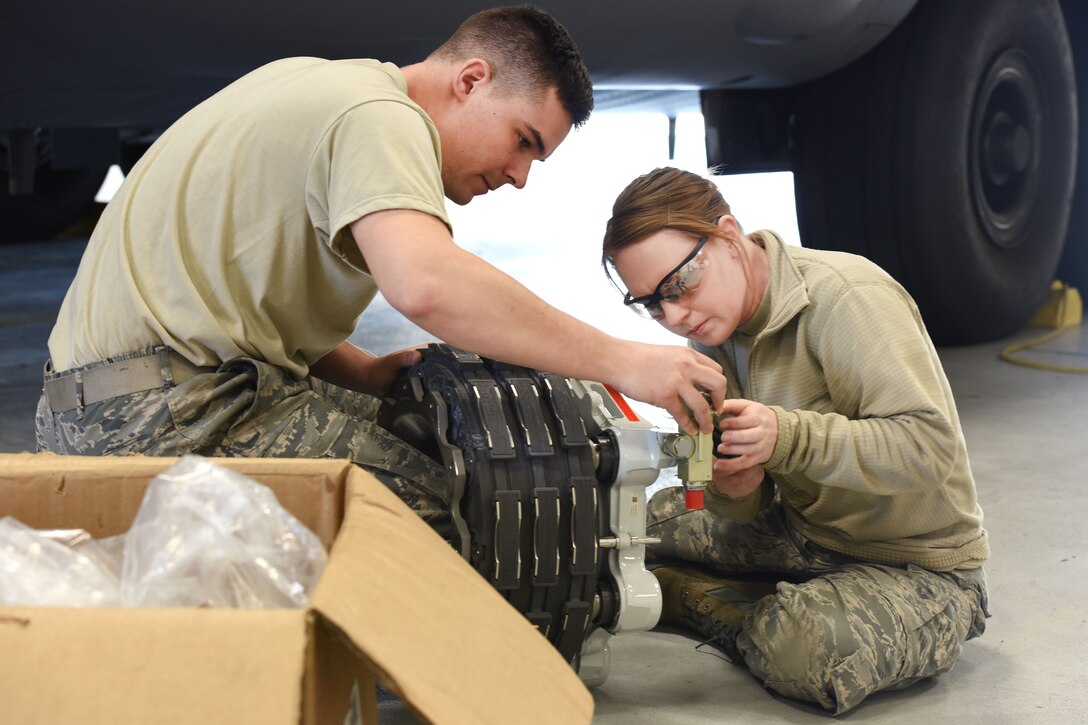 Pennsylvania Air National Guard Staff Sgt. Emery Barrett and Airman 1st Class Reanna Keener move a shuttle valve to the correct side of an aircraft brake assembly in Middletown, Pa., April 5, 2017. Air National Guard photo by Master Sgt. Culeen Shaffer