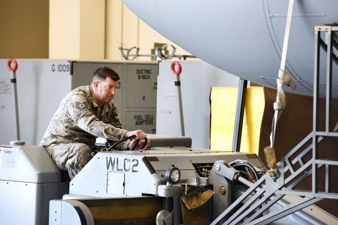 Pennsylvania Air National Guard Tech. Sgt. Michael Richer uses a bomb loader to place an antenna pod in place so that it can be reattached to an EC-130J Commando Solo aircraft in Middletown, Pa., April 5, 2017. Richer is an aircraft electronics mechanic assigned to the Pennsylvania Air National Guard’s 193rd Special Operations Maintenance Squadron. Air National Guard photo by Master Sgt. Culeen Shaffer