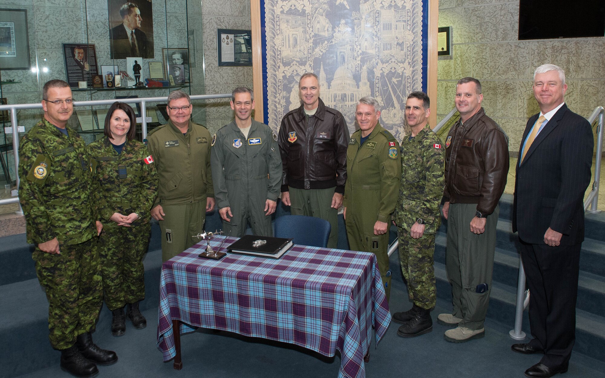 Commanders from across the North American Defense Command enterprise met April 11 at 1 Canadian Division Headquarters, 17 Wing, in Winnipeg, Manitoba, Canada to discuss their mutual mission requirements. Here, gathered around the headquarters guest book are: (L-R) 1 CAD Chief Warrant Official Serge Laforge; Lt Col Marcy Spiers, 1 CAD HQ Commanding Officer; Brig Gen Paul Ormsby, Deputy Commander, Continental U.S. North American Aerospace Defense Command Region; Lt.  Gen. Kenneth Wilsbach, Commander, Alaskan NORAD Region; Lt. Gen. R. Scott Williams, Commander, CONR-1st Air Force (Air Forces Northern); Maj Gen Christian Druin, 1 CAD Commander; 1 CAD CWO Michael Scarcella; Brig. Gen. Dan Orcutt, Vice Commander, 1st Air Force (Air Forces Northern)  and Van Wimmer, CONR-1AF(AFNORTH) liaison officer to NORAD-U.S. Northern Command. (Photo by Cpl Justin Ancelin, 17 Wing Imaging)